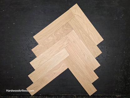 4" x 20" x 3/4" Solid Unfinished White Oak Herringbone Hardwood Flooring. Close up of a box. 