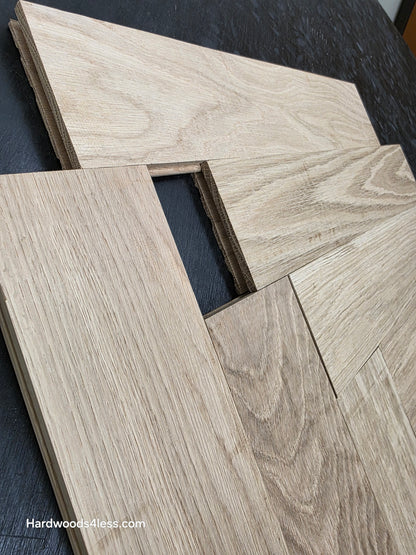 4" x 20" x 3/4" Solid Unfinished White Oak Herringbone Hardwood Flooring. Shown on a black shooting table. Shot very close up. To highlight the grooves. 