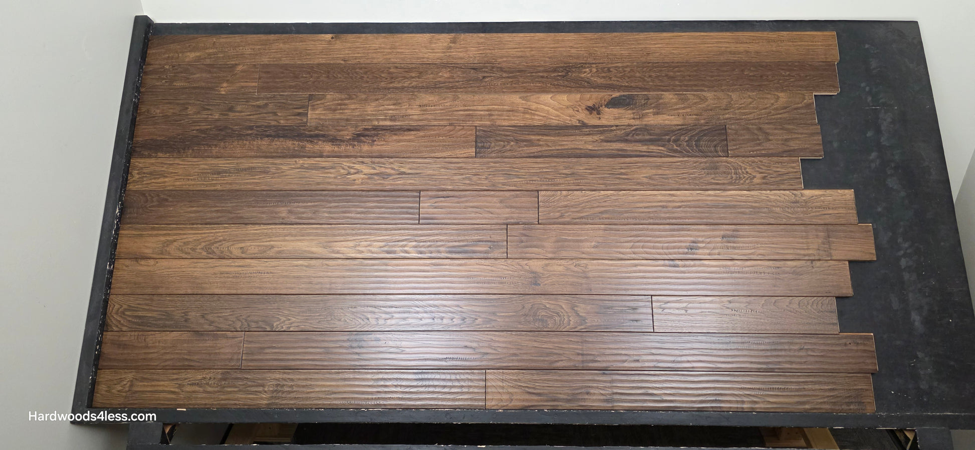 4" x 3/4" Hickory Calico Hardwood Flooring. Shown on a black shooting table. Center shot. 