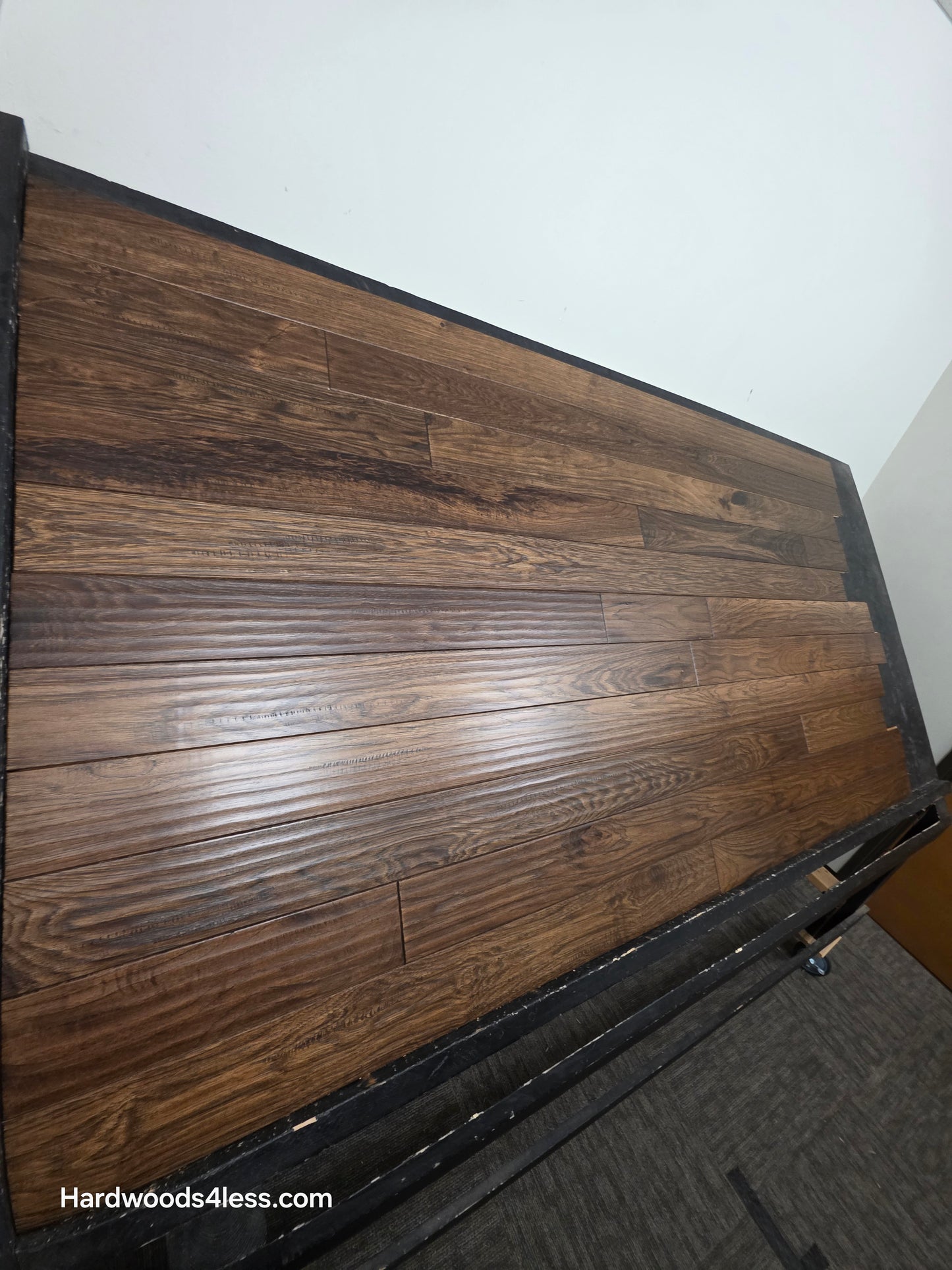 4" x 3/4" Hickory Calico Hardwood Flooring. Shown on a black shooting table. Shot steeply from the left hand side. 