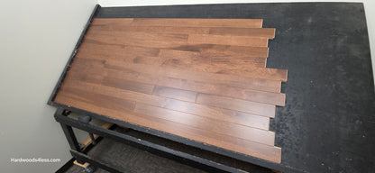 4" x 3/4" Solid Hickory Cortado Hardwood Flooring. show on a black shooting table. Shot from wide right.