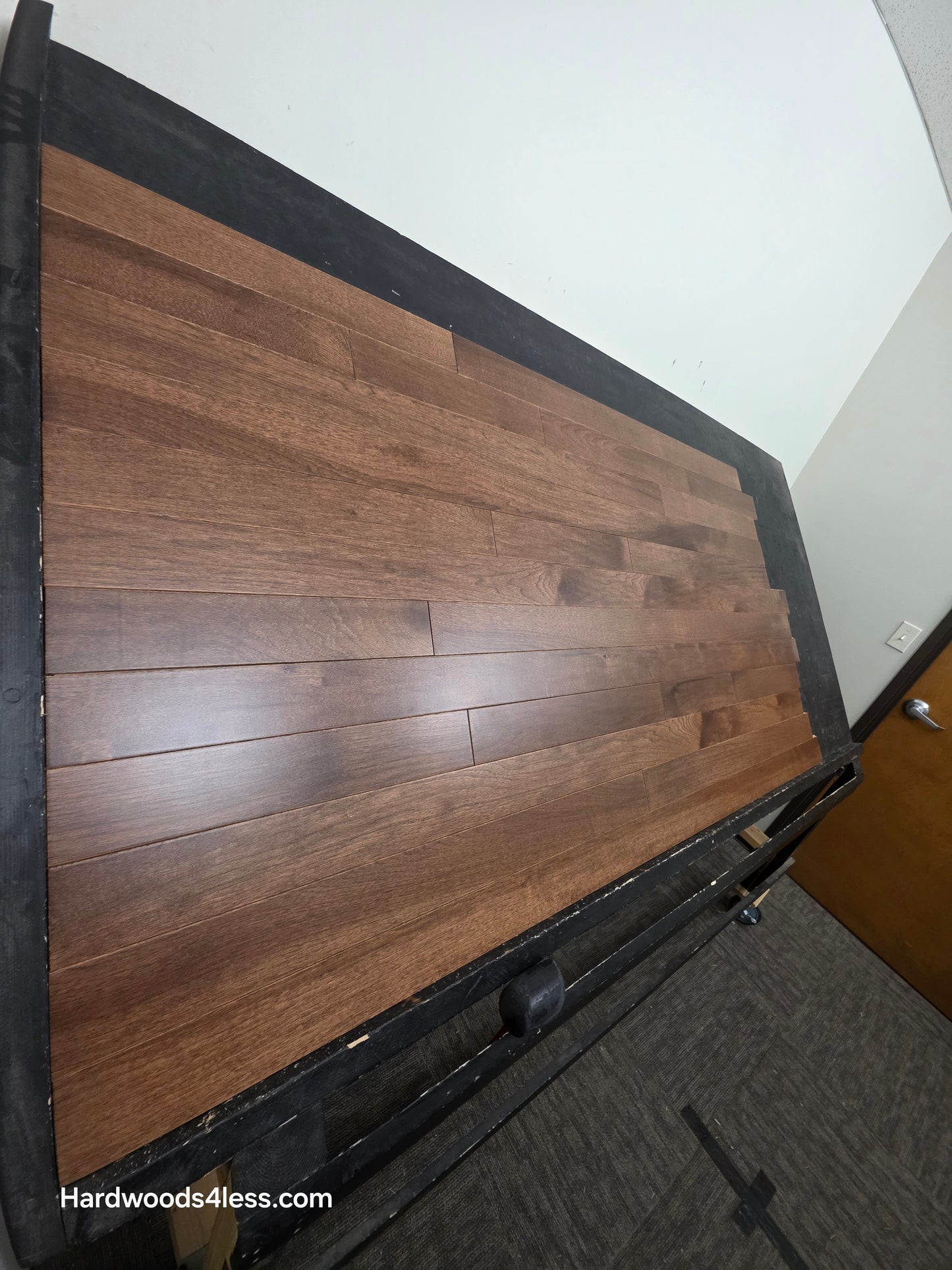 4" x 3/4" Solid Hickory Cortado Hardwood Flooring. Shown on a black shooting table. shot from steep left. 