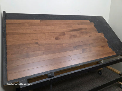 4" x 3/4" Solid Hickory Cortado Hardwood Flooring. Shown on a black shooting table. shot from wide left. 