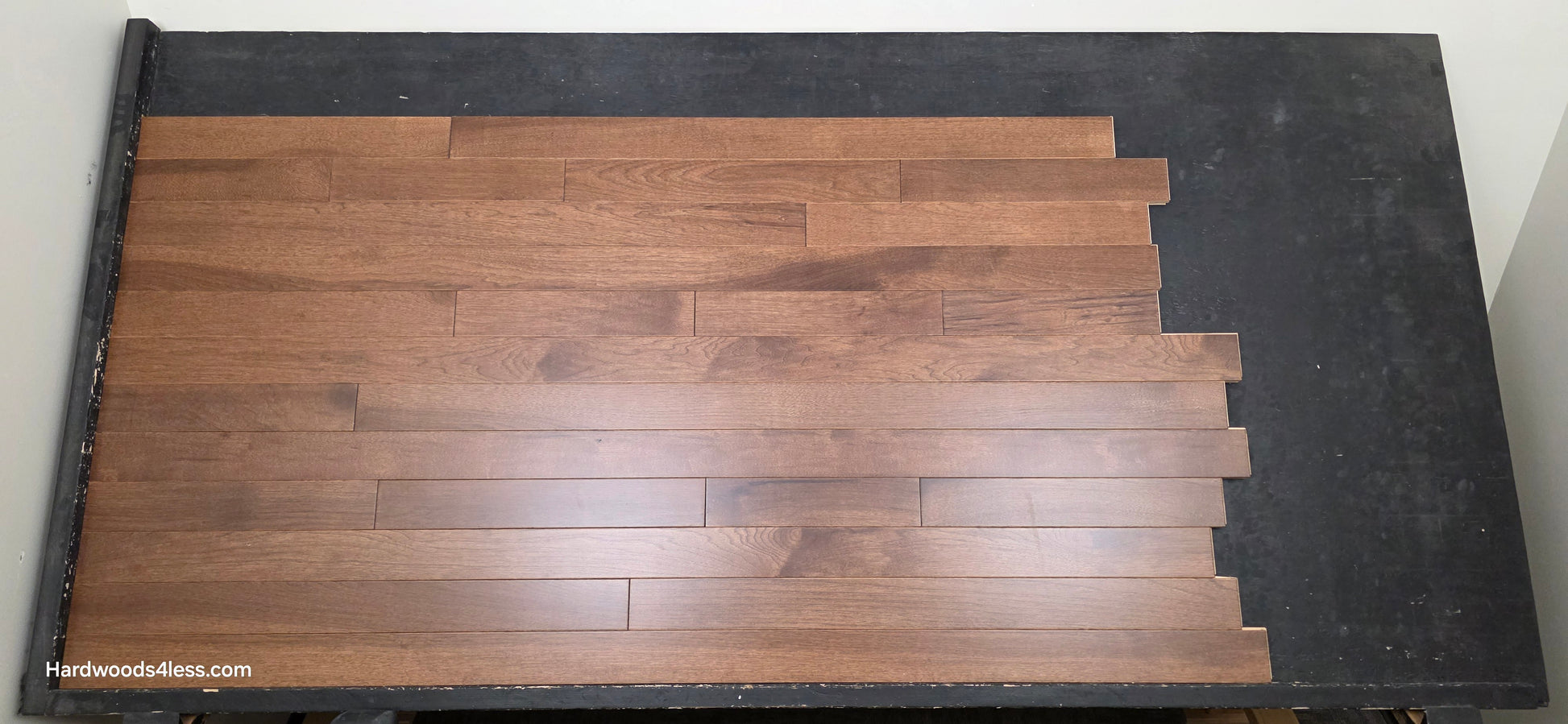 4" x 3/4" Solid Hickory Cortado Hardwood Flooring. Shown on a black shooting table. shot from center.