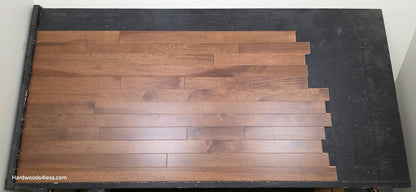 4" x 3/4" Solid Hickory Cortado Hardwood Flooring. Shown on a black shooting table. shot from center.