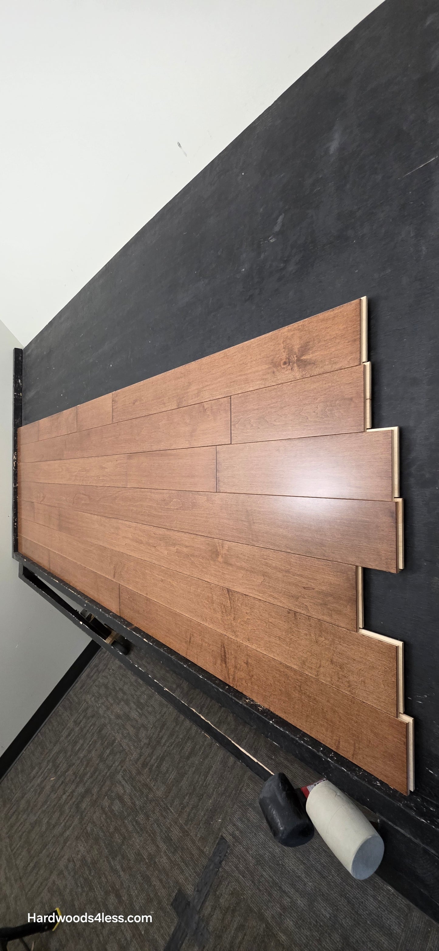 4" x 3/4" Solid Maple Hazelnut Hardwood Flooring. Shown on a black shooting table. Shot from steep right