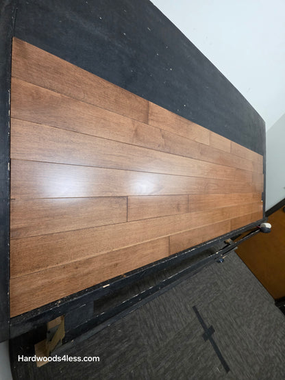 4" x 3/4" Solid Maple Hazelnut Hardwood Flooring. Shown on a black shooting table. Shot from steep left.