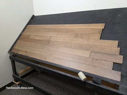 4" x 3/4" Solid Maple Sandpiper Hardwood Flooring. Shown on a black shooting table. shot from the right side. 
