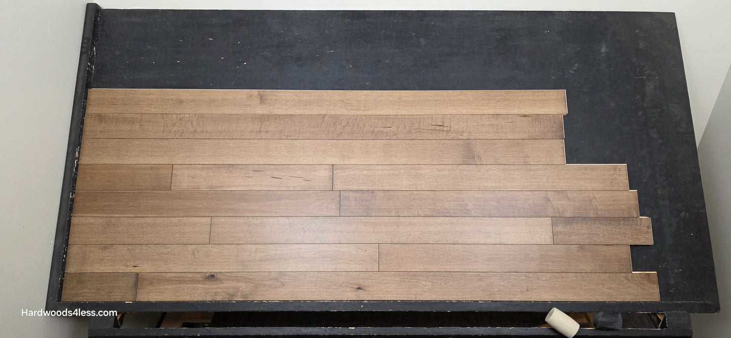 4" x 3/4" Solid Maple Sandpiper Hardwood Flooring. Shown on a black shooting table. Shot from center. 