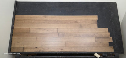 4" x 3/4" Solid Maple Sandpiper Hardwood Flooring. Shown on a black shooting table. Shot from center. 