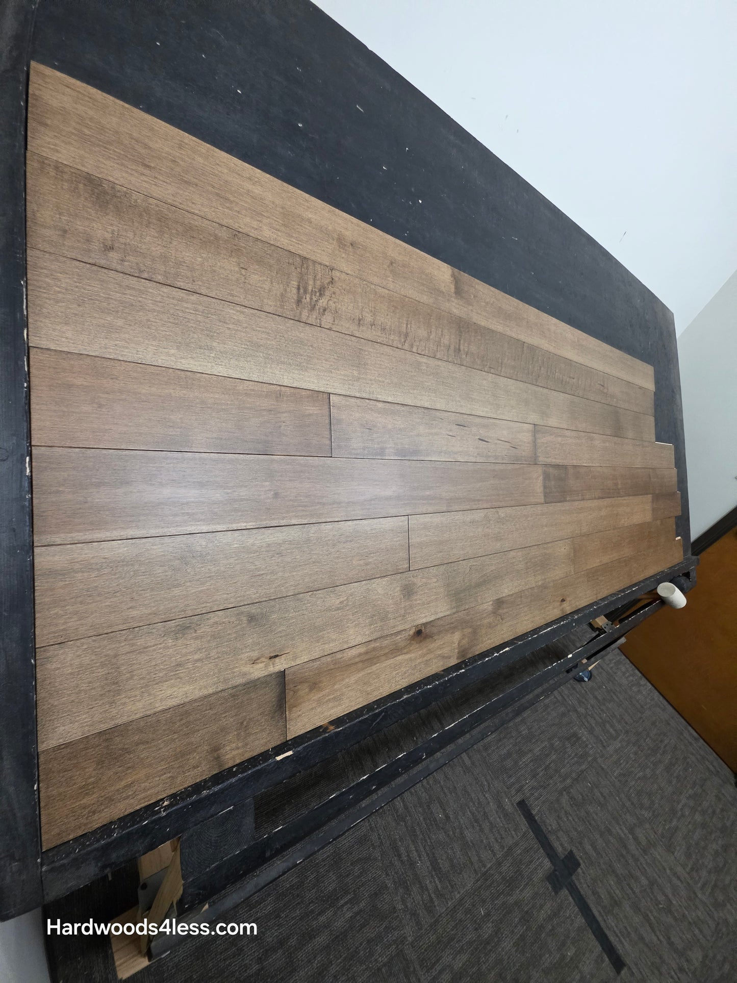 4" x 3/4" Solid Maple Sandpiper Hardwood Flooring. Shown on a black shooting table. shot from the left side. 