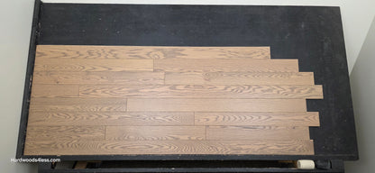 4" x 3/4" Solid Red Oak Barrel Hardwood Flooring. Shown on a black shooting table. Shot from center.
