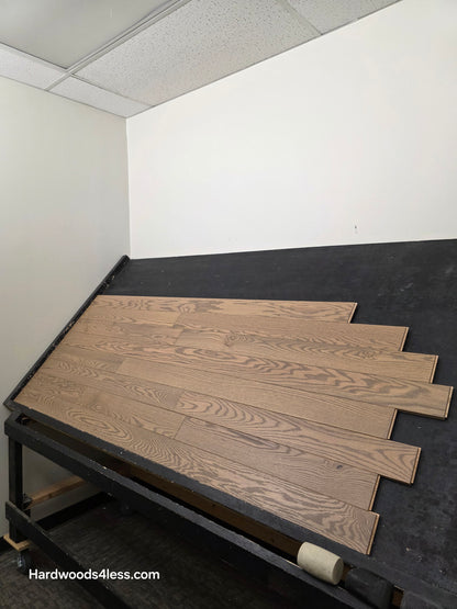 4" x 3/4" Solid Red Oak Barrel Hardwood Flooring. Shown on a black shooting table. Shot from left.