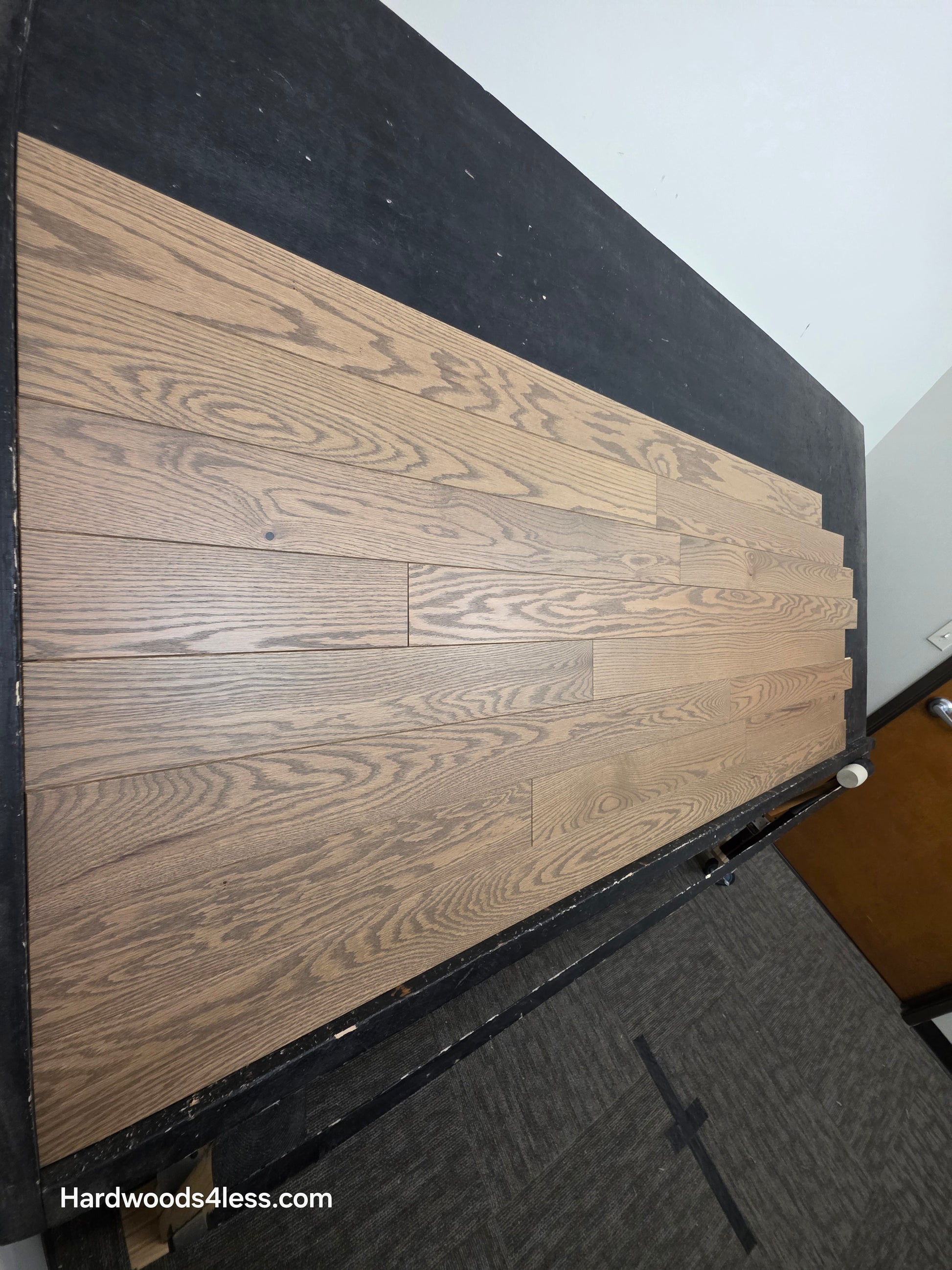 4" x 3/4" Solid Red Oak Barrel Hardwood Flooring. Shown on a black shooting table. Shot from steep left.