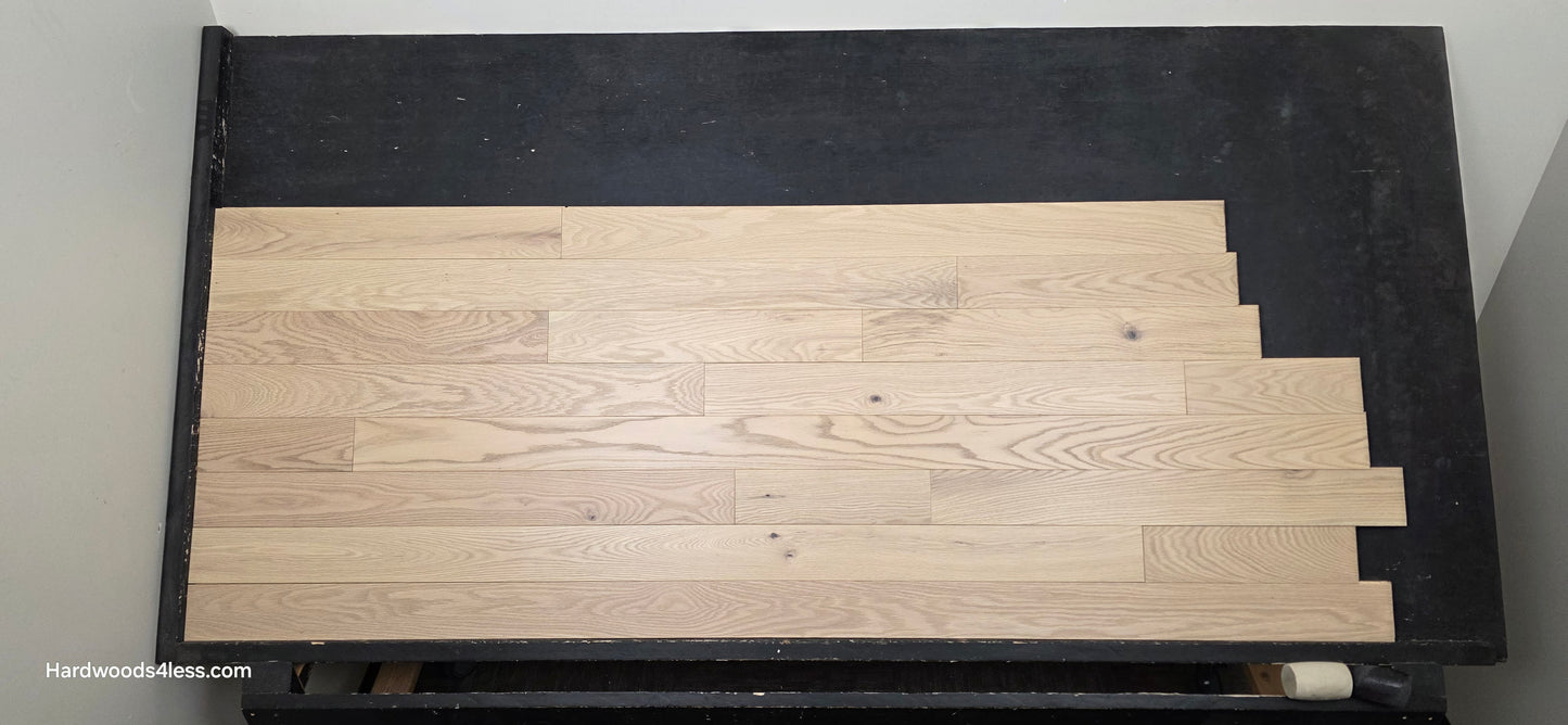 4" x 3/4" Solid Red Oak Doe Hardwood Flooring. Shown on a black shooting table. Shot from center. 
