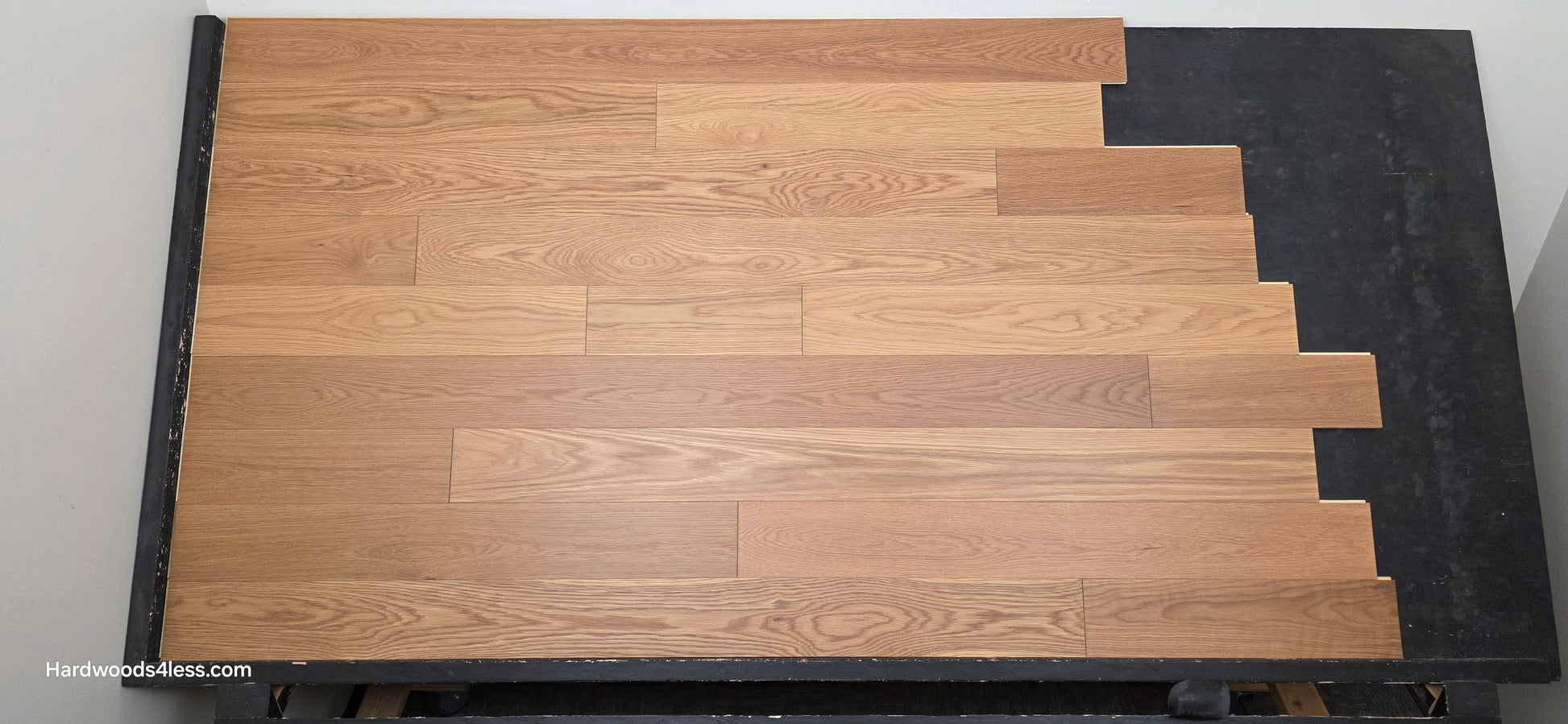 5 1/8" x 1/2"  Engineered White Oak Select & Better Natural Hardwood Flooring. Shown on a black shooting table. Center shot.