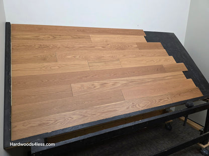 5 1/8" x 1/2"  Engineered White Oak Select & Better Natural Hardwood Flooring. Shown on a black shooting table. Left angle shot. 