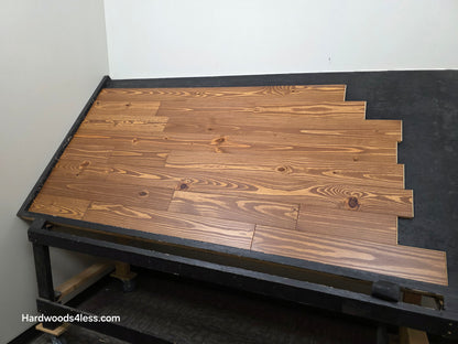 5 1/8" x 3/4" Southern Yellow Pine Nectar Solid Hardwood Flooring. Shown  on a black shooting rack.  Shot from the right hand side. 