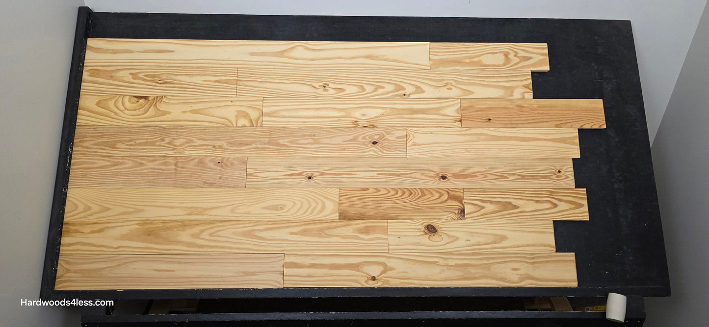  5 1/8" x 3/4" Southern Yellow Pine Wire Brushed Natural Solid Hardwood Flooring. Shown on a black shooting table. Shot head on. 