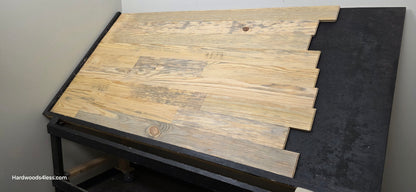 5 1/8" x 3/4" Unfinished Southern Yellow Pine Solid Flooring. Shown on a black shooting rack. Shot from the right hand side.