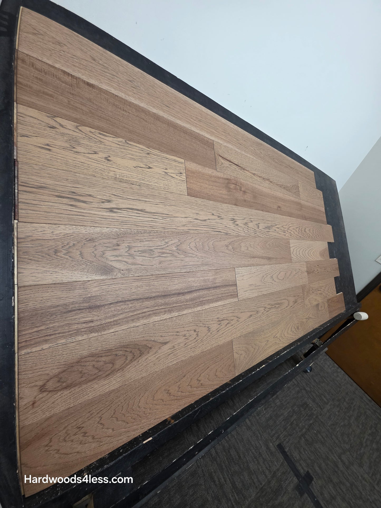 5 38 x 12 Engineered Hickory Cunningham Hardwood Flooring. Shown on a black shooting table. Shot from steep left.