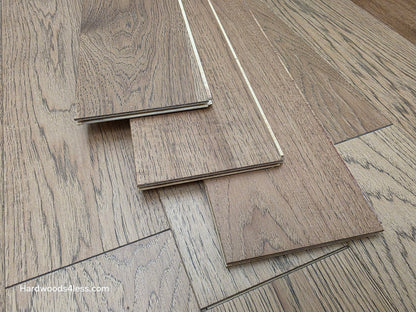 5 38 x 12 Engineered Hickory Cunningham Hardwood Flooring. Shown as three boards stacked on the floor. 