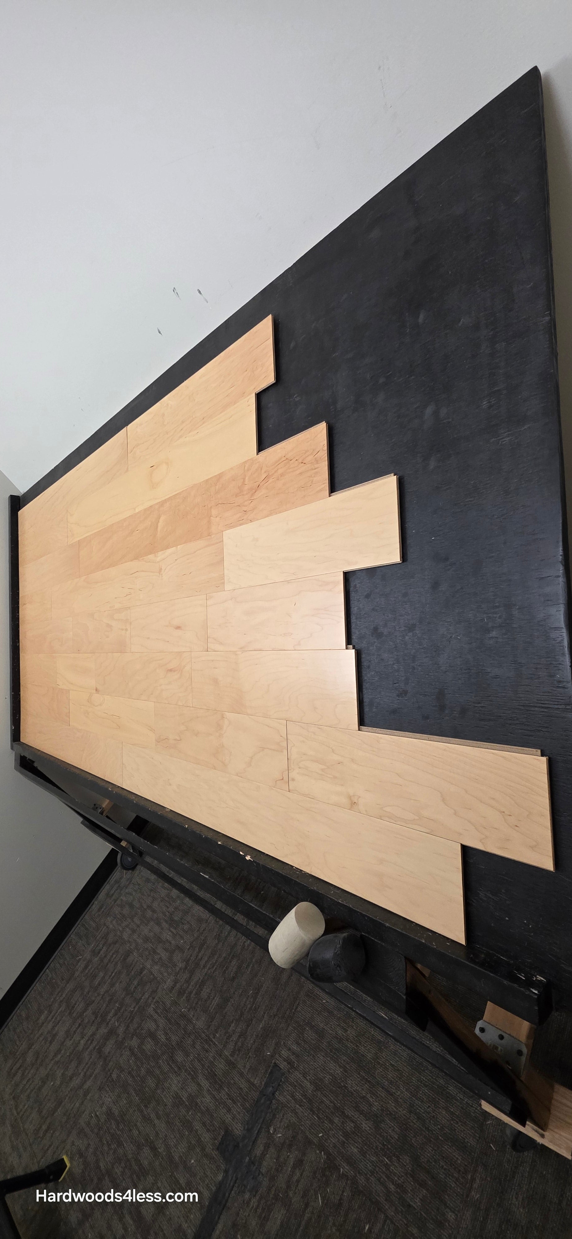 5 3/8" x 3/8" Engineered Maple Natural Hardwood Flooring. Shown on a black shooting table. Shot from steep right.