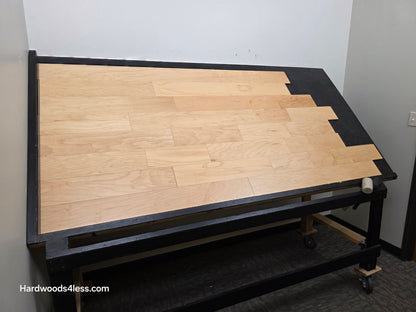 5 3/8" x 3/8" Engineered Maple Natural Hardwood Flooring. Shown on a black shooting table. Shot from wide left. 