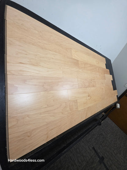 5 3/8" x 3/8" Engineered Maple Natural Hardwood Flooring. Shown on a black shooting table. Shot from steep left. 