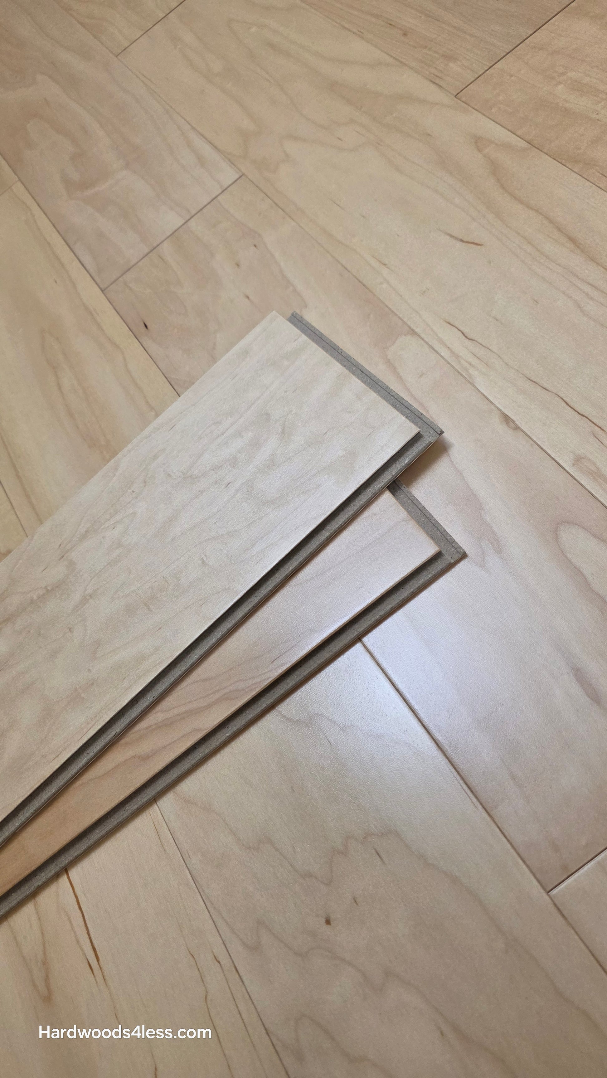 5 3/8" x 3/8" Engineered Maple Natural Hardwood Flooring. Shown with 2 planks resting in the center of the maple flooring. 