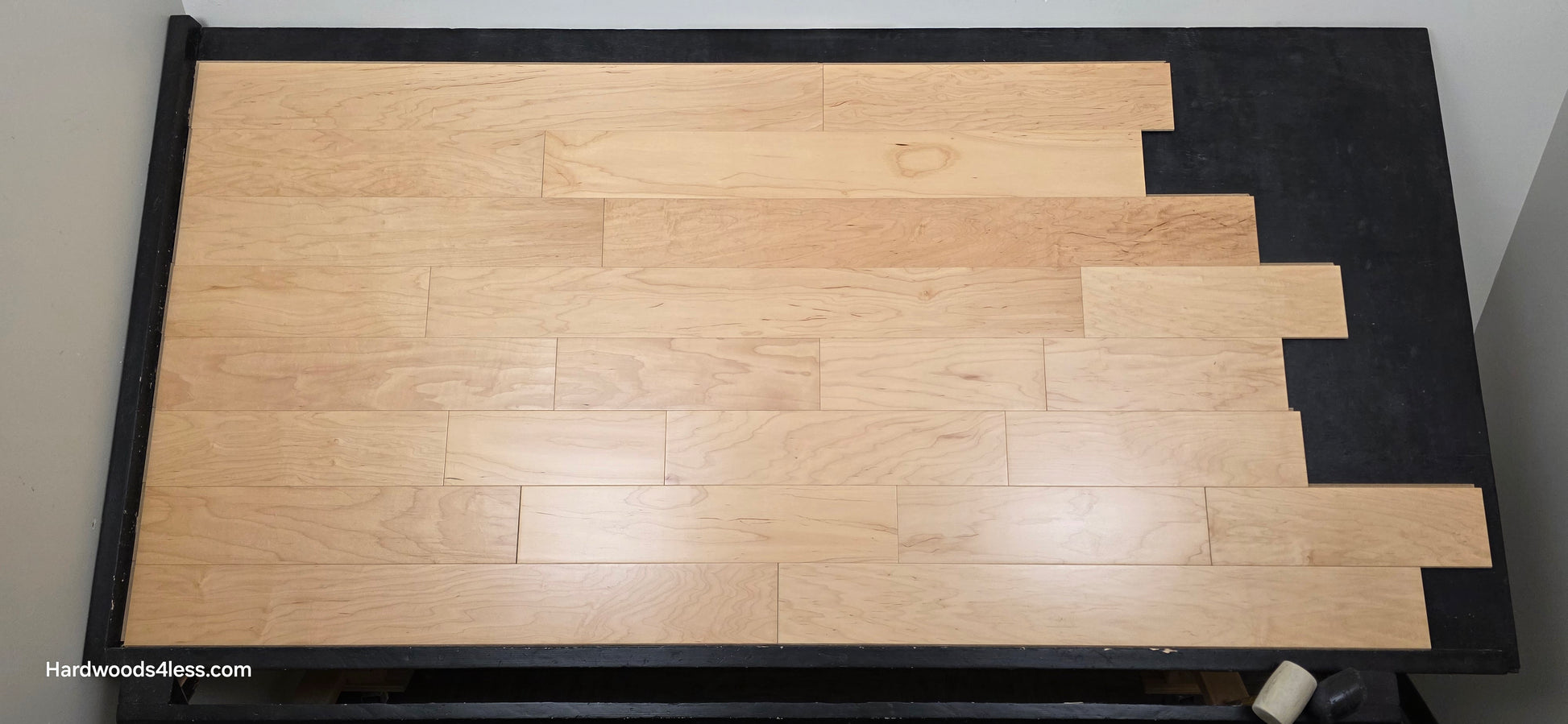 5 3/8" x 3/8" Engineered Maple Natural Hardwood Flooring. Shown on a black shooting table. Shot from center.