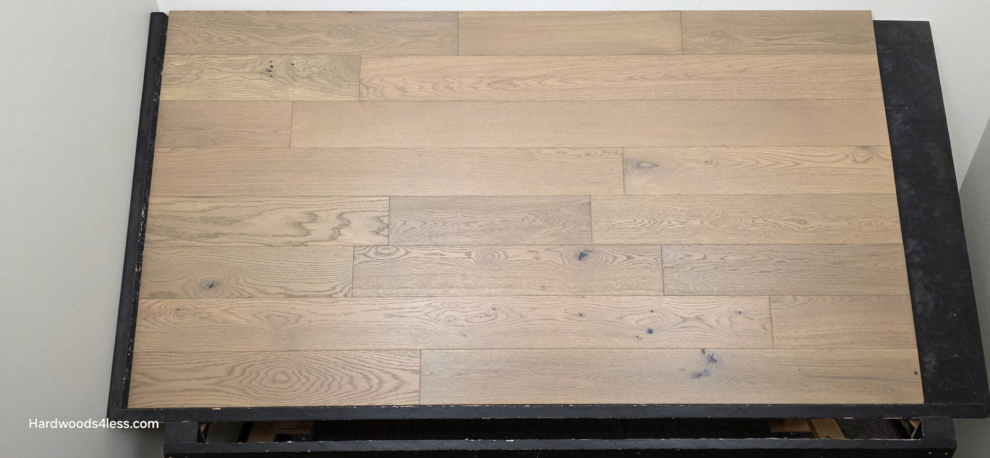 5 7/8" x 9/16" Engineered European Oak Cades Cove Hardwood Flooring. Shown on a black shooting table. Head on.
