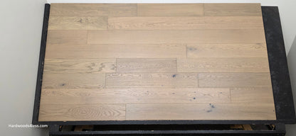5 7/8" x 9/16" Engineered European Oak Cades Cove Hardwood Flooring. Shown on a black shooting table. Head on.