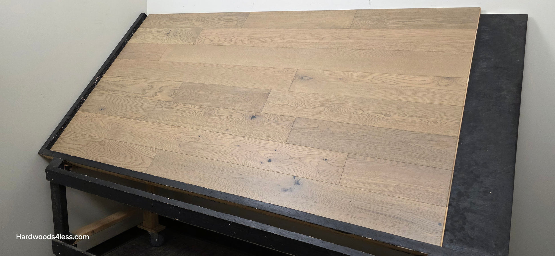 5 7/8" x 9/16" Engineered European Oak Cades Cove Hardwood Flooring. Shown on a black shooting table from the right side. 