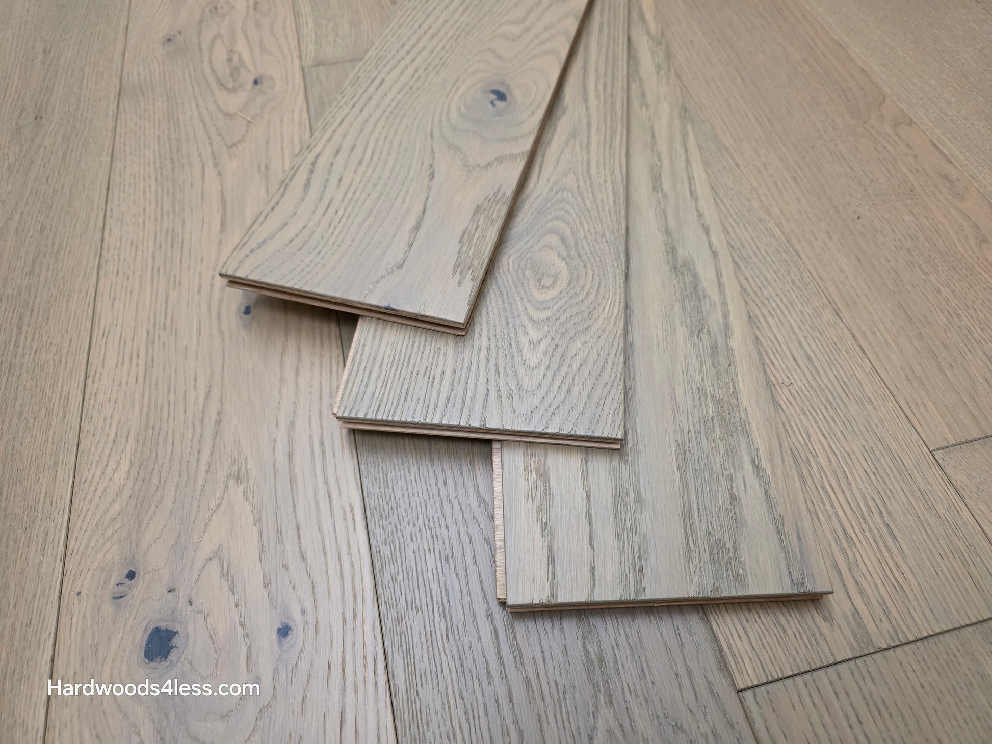 5 7/8" x 9/16" Engineered European Oak Cades Cove Hardwood Flooring shown with three boards stacked on top of the floor. 
