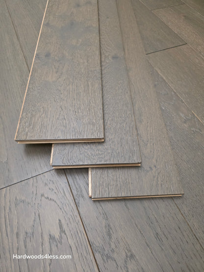 5 7/8" x 9/16" Engineered European Oak Mount Mitchell Hardwood Flooring. Shown with three boards stacked atop the flooring. 