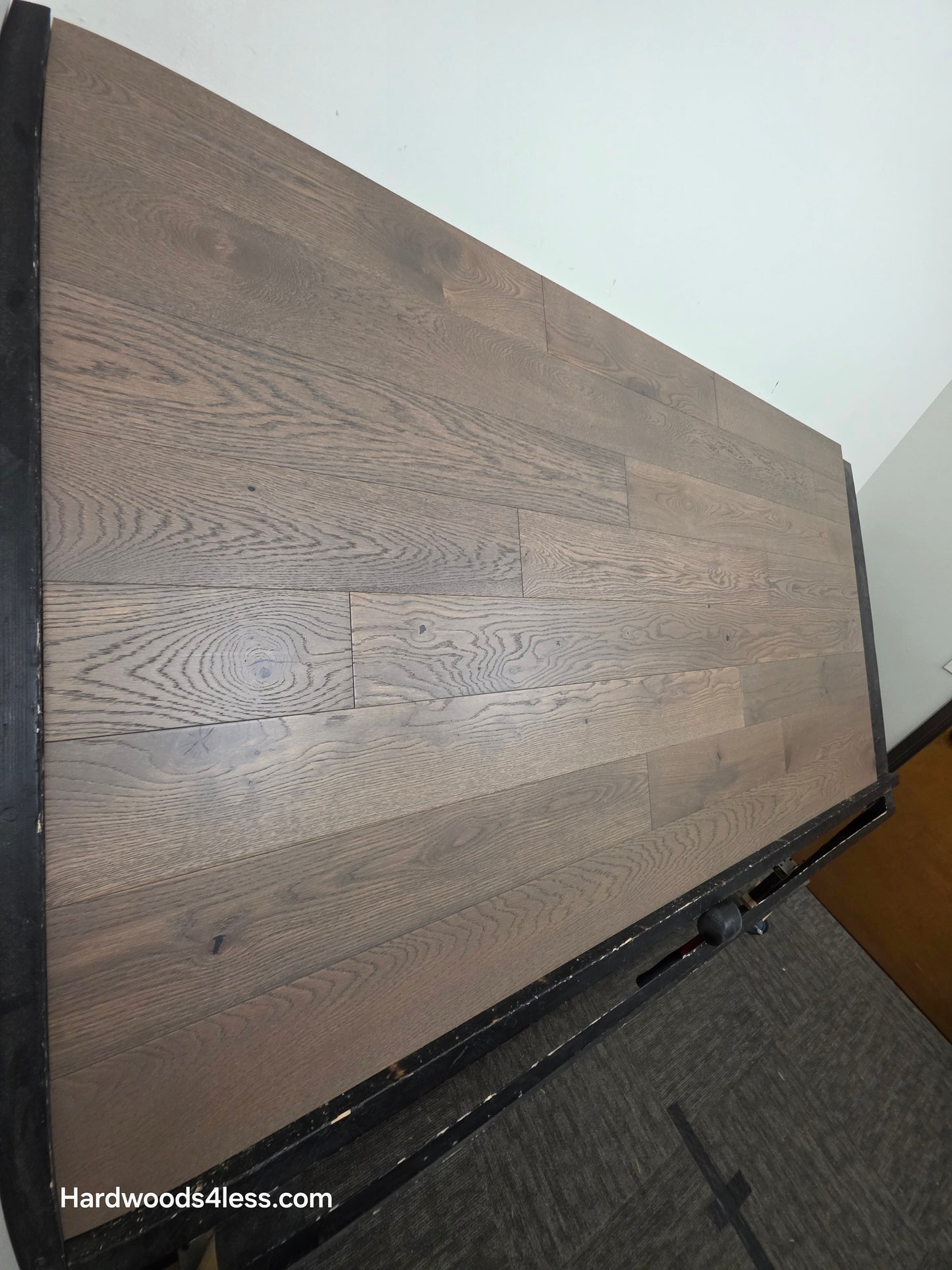 5 7/8" x 9/16" Engineered European Oak Roanoke Ridge Hardwood Flooring shown on a black shooting table. shot from the left hand side. 