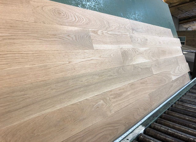 5" x 3/4" Unfinished White Oak Select & Better Solid Hardwood Flooring shown on a green shooting table