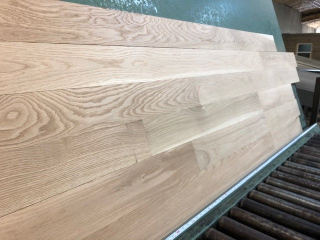 5" x 3/4" Unfinished White Oak Select & Better Solid Hardwood Flooring shown on a green shooting table