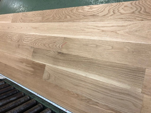 5" x 3/4" Unfinished White Oak Select & Better Solid Hardwood Flooring shown on a green shooting table