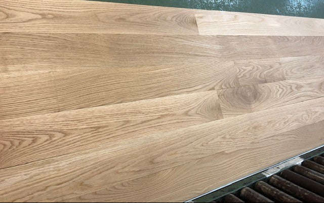 5" x 3/4" Unfinished White Oak Select & Better Solid Hardwood Flooring shown on a green shooting table
