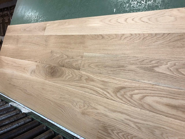 5" x 3/4" Unfinished White Oak Select & Better Solid Hardwood Flooring shown on a green shooting table