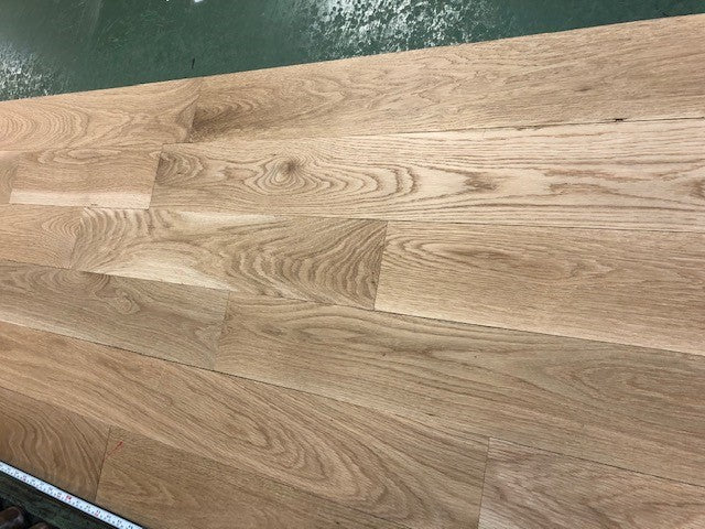 5" x 3/4" Unfinished White Oak Select & Better Solid Hardwood Flooring shown on a green shooting table