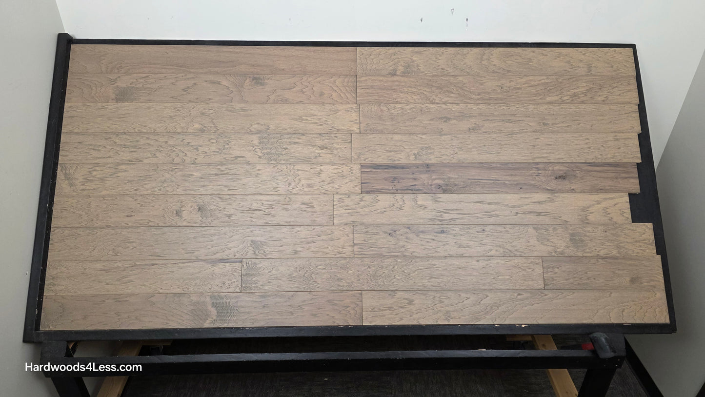 5" x 1/2" Engineered Hickory Flagstone Hardwood Flooring. Shown on a black shooting table. Shot from center.