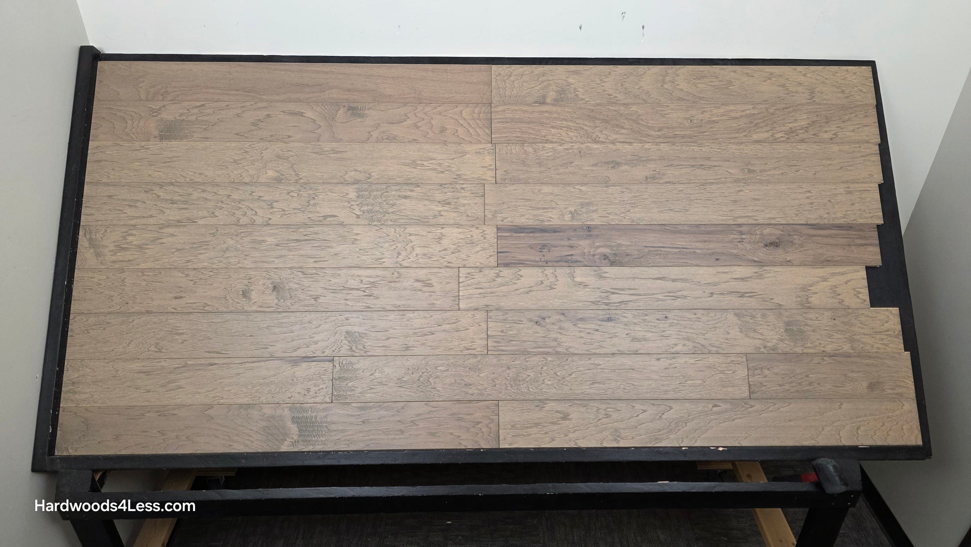 5" x 1/2" Engineered Hickory Flagstone Hardwood Flooring. Shown on a black shooting table. Shot from center.
