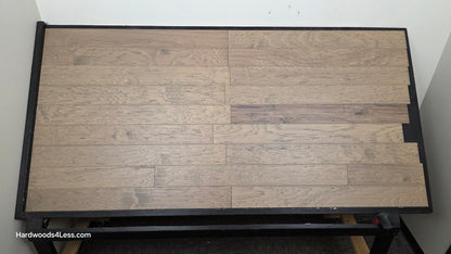5" x 1/2" Engineered Hickory Flagstone Hardwood Flooring. Shown on a black shooting table. Shot from center.