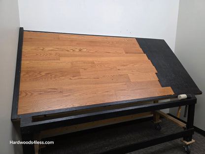 5" x 1/2" Engineered Red Oak Golden Oak Hardwood Flooring. Shown on a black shooting table. Shot from wide left.