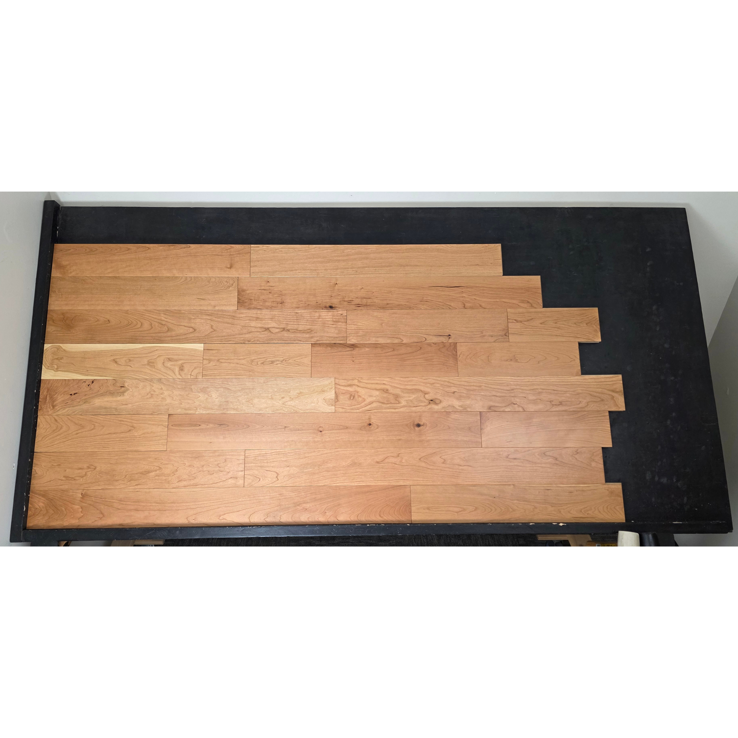 5" x 3/4" American Cherry Natural Hardwood Flooring shown on a black shooting table. Shot at center.