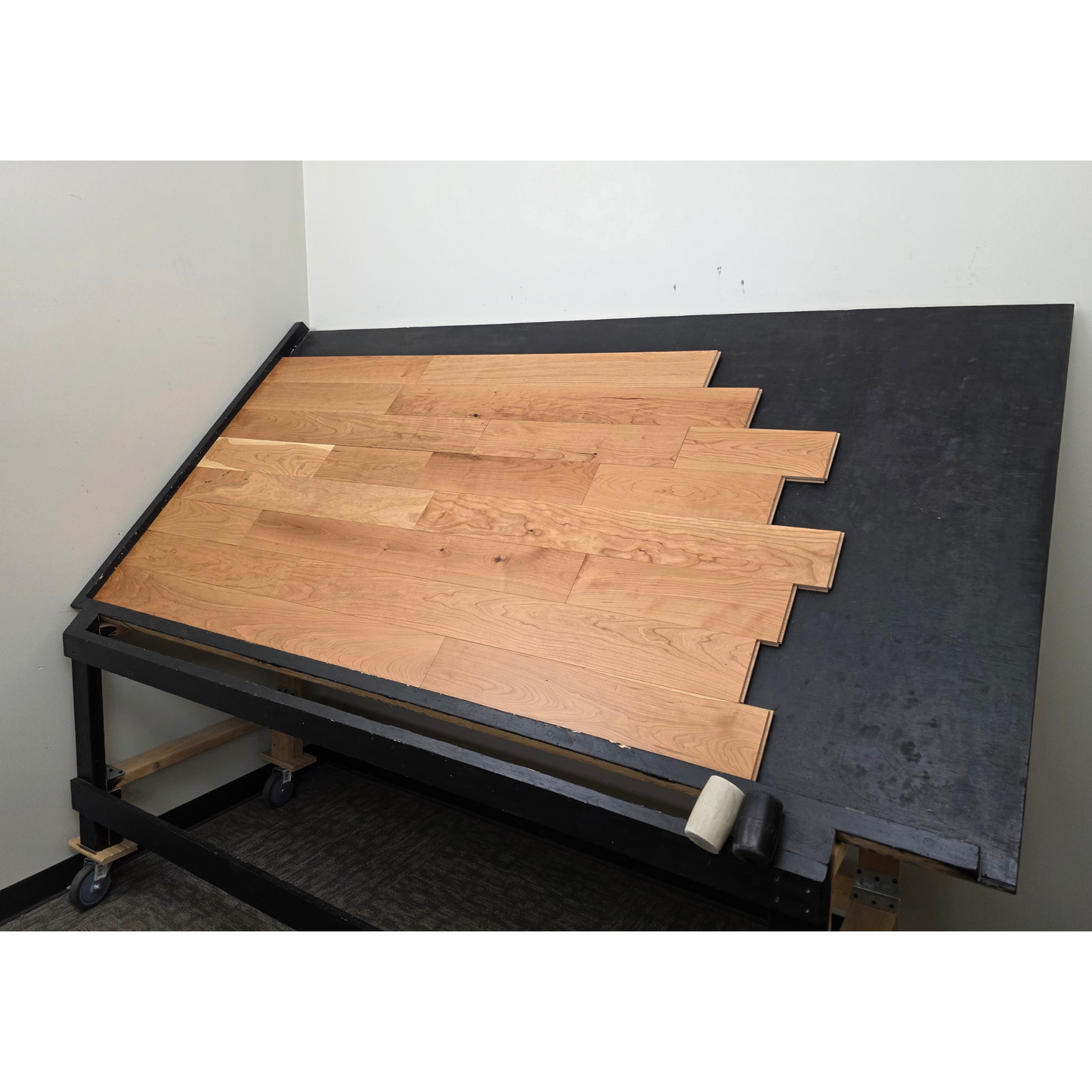 5" x 3/4" American Cherry Natural Hardwood Flooring shown on a black shooting table. Shot from wide right.