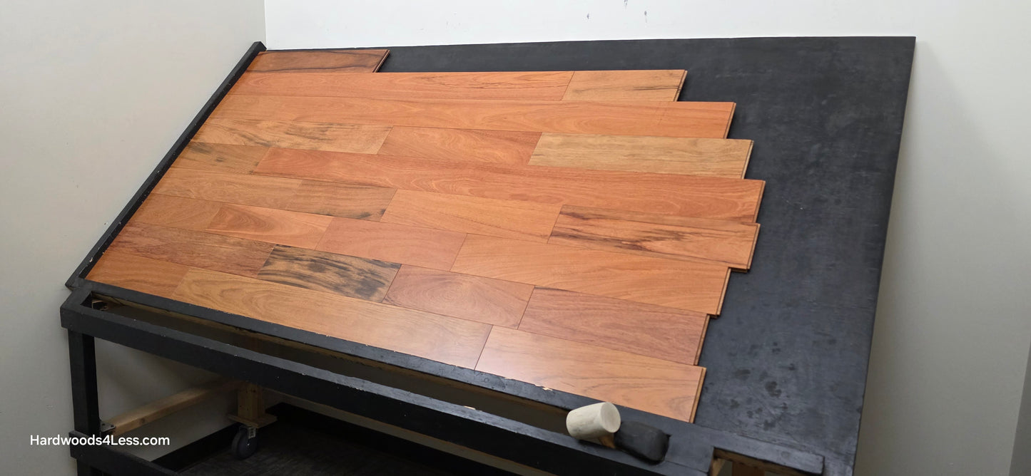 5" x 3/4" Prefinished Brazilian Cherry Shorts Hardwood Flooring. Shown on a black shooting table. Shot from wide right.